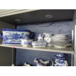 A mixed lot of blue and white ceramics including a large footbath, serving bowls, plates, and