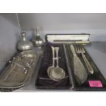 Silver plate to include salad servers, fish servers, a salt and pepper, knife rests, two candle