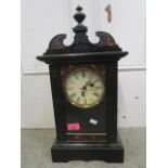 An early 20th century ebonized and simulated tortoiseshell effect cased mantel clock, with painted