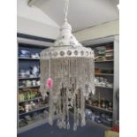 A white painted metal light with pierced ornamental and chain pendants