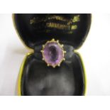 A 9ct gold and amethyst coloured cabochon ring