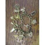 A 9ct gold charm bracelet and mixed charms