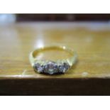 An 18ct yellow gold and platinum set, three stone diamond ring