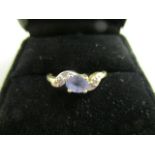 A gold and tanzanite ring with certificate of authenticity