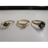 A group of three gold rings to include a French 18k diamond solitaire ring, a sapphire cluster