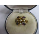 A yellow metal ring stamped 14k with an amethyst coloured stone and seed pearls