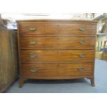 A George III mahogany bow front dressing chest, the top drawer enclosing a green baize slide,