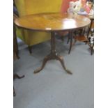 A 19th century oak tilt top occasional table on a tripod base