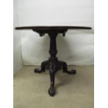 A George III mahogany pedestal table having a tip top, over a turned column, raised on a tripod base