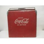 A mid 20th century Action MFG Co red and white painted metal Coca Cola cooler box with a chrome