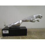 A large chrome model of a jaguar car mascot, mounted on a black composition base