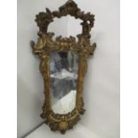 A 19th century continental mirror in a carved softwood and gilt gesso frame with scrolled, foliate