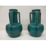 A pair of early 20th century Japanese green glazed vases with a cylindrical with neck, three angular