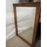 A late Victorian grained gesso picture frame decorated with flowers, foliage and scrolls with a