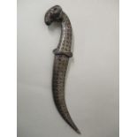 An Indian Niello white metal dagger with a Damascus curved blade, rams head pommel and Niello