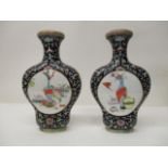 A pair of early 20th century Chinese moon vases with flared necks, each decorated with two panels of