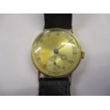 A 1940s 9ct gold gents wristwatch having a 15 jewel movement, the silvered dial (tarnished) having