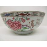 A late 18th century Chinese porcelain famille rose bowl decorated with peonies, trees, birds insects