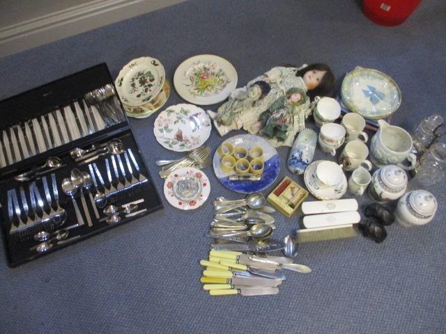 A mixed lot to include table ware, cups and saucers, dolls, dressing table items, cutlery and