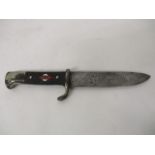 A WWII German Hitler Youth knife, the textured handle inset with a red and white diamond motif and