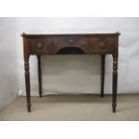 A Victorian mahogany desk having a cast, gilt metal, pierced gallery, over a central drawer and