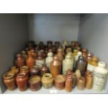 A collection of Victorian and later stoneware ginger beer bottles and other bottles to include