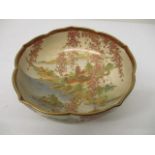 An early/mid 20th century Japanese Satsuma bowl with a lobed edge decorated with a river scene and