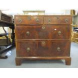 An early 18th century walnut chest of two short and two deep drawers, with brass ring handles,