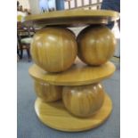 A modern designer, light oak, 'Sphere' table having three discs, separated by six spheres, 25 1/2"