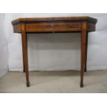 A George III mahogany and satinwood card table having a foldover top, enclosing green baize,