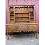 A George II and later satinwood and ebony inlaid oak dresser, the upper part having a fret-worked