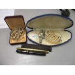 A mixed lot to include two faux pearl necklaces, a wristwatch and two pens
