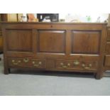 An early 20th century oak chest having a flush panelled top over a mitred, panelled front and twin