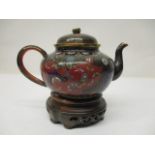 An early 20th century Japanese cloisonne teapot of bulbous form with a domed lid, decorated with