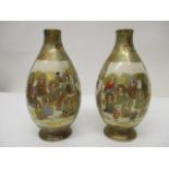 A pair of early 20th century Japanese Satsuma vases of ovoid form decorated with panels of figures