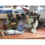 Carved wooden animals, figures, a cast metal dog, glass fish, vases and other items