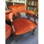 An early 20th century open armchair with terracotta velour upholstery