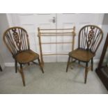 A pair of early 20th century country Windsor chairs and a modern pine towel rail