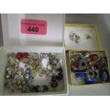 A mixed assortment of stud earrings and pendant earrings and a selection of silver and white metal