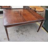 A 1920s mahogany dining table having applied moulding on tapering legs, 29 1/4" h x 53 1/4" w, a