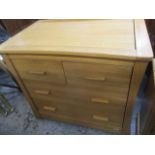 A modern pale oak chest of four drawers with a removable top panel, for changing a baby, 34"h, 38" w