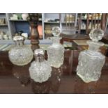 Two early 20th century cut glass dressing table bottles of globular form, hobnail cut with silver