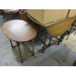 A 1930s oak gate leg table, 28 1/2"h x 35"w, and a two tier oak occasional table, 24"h x 26"w