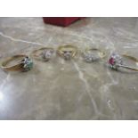 Five 9ct gold rings, each set with clear stones, one with a red stone and another with green, 12g