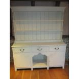 An early 20th century white painted Shabby Chic dresser with plate rails above