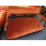 An early 20th century settee with terracotta velour upholstery