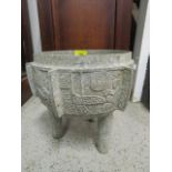 A Peruvian Aztec style metal cauldron, standing on three legs