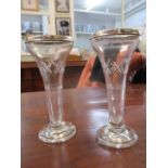 A pair of early 20th century clear trumpet shaped vases with silver rims, London 1924