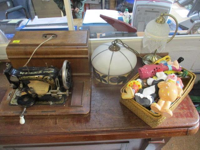 A mixed lot to include a sewing machine, light fittings, a lamp and child-related bottles