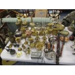 A selection of metalware to include candlesticks, mugs, bed warmers, figures and other items